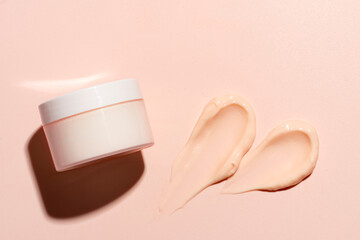 Pink peach cosmetic cream sample and jar