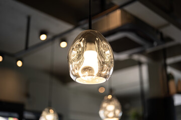 A cozy designed sphere ceiling lighting lamp during glowing in yellow warmlight shade 