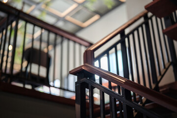 Close-up at building stairway banister wooden handrail in vintage style. Interior building and...