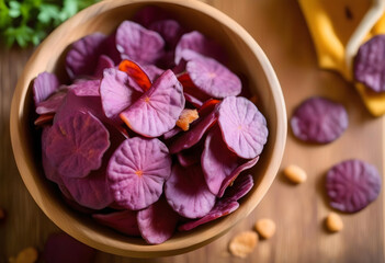 A bowl filled with purple sweet potato chips in the wooden table