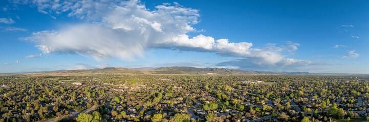 early morning with clouds over Fort Collins and foothills of Rocky Mountains in northern Colorado,...
