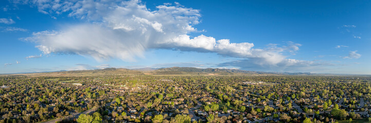 Fototapeta premium early morning with clouds over Fort Collins and foothills of Rocky Mountains in northern Colorado, springtime aerial panorama