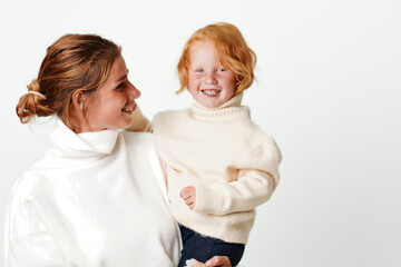 Mother and daughter outfit coordination stylish white turtleneck sweater and jeans for family...