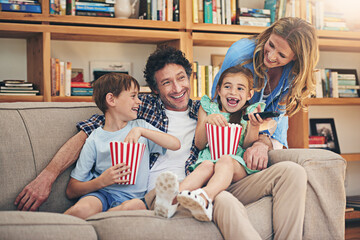 Happy family, relax and laughing with popcorn for comedy movie, weekend or holiday on living room...