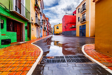 Houses reflected in puddles in the old town of Villajoyosa