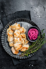 BBQ chicken shish kebab skewers, Shashlik with onion and spices. Black background. Top view