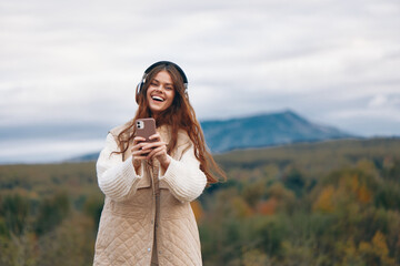Mountain Freedom: Woman Smiling, Taking a Selfie on Her Phone during an Adventure Hiking Trip.