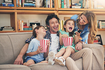 Happy family, relax and laughing with popcorn for funny movie, weekend or holiday on living room...
