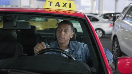 African American taxi driver smoking an electronic cigarette. .