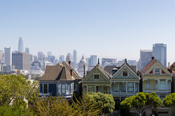 the unique and famous row of old houses called the painted ladies at Alamo square park in San...