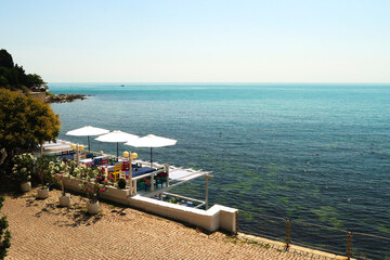 Picturesque view onto the deep blue sea from the old town of Nessebar, Nesebar with a restaurant...