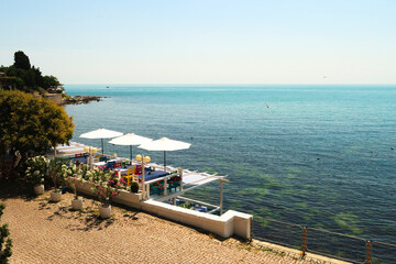 Beautiful view onto the deep blue sea from the old town of Nessebar, Nesebar with a restaurant...