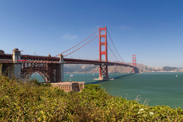 the unique and world famous Golden Gate Bridge at a clear sky sunny morning in san francisco