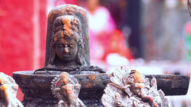 an ancient shivling with ganesha sculptures