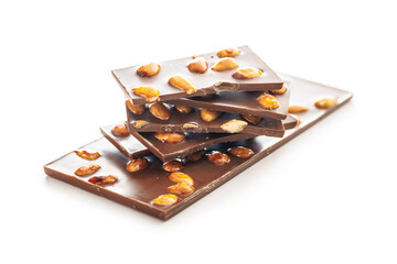 Broken chocolate bar with almonds isolated on white background.
