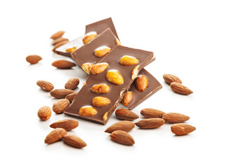 Broken chocolate bar with almonds isolated on white background.