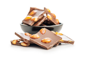 Broken chocolate bar with almonds isolated on white background.