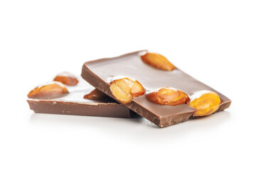 Broken chocolate bar with almonds isolated on white background.