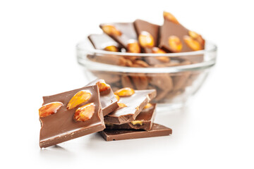 Broken chocolate bar with almonds isolated on white background.