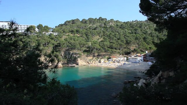 General view of Aiguablava cove surrounded by pine trees and cliffs. Begur, Costa Brava, Catalonia, Spain.