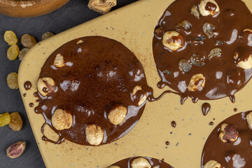 making homemade chocolate with cocoa butter and nuts