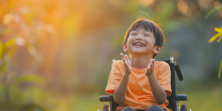 happy asian boy child clapping hands on a wheelchair. Blissful Wheels: Spreading Joy in Adaptive Mobility.