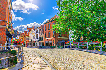 Fototapeta premium Brugge city historical center, empty street Mill Bridge Molenbrug, paving stone road, colorful buildings in Bruges old town Sint-Anna quarter medieval district, West Flanders province, Belgium