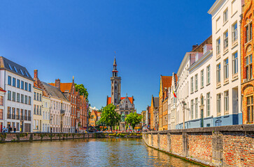 Naklejka premium Bruges cityscape, Spiegelrei water canal, Poortersloge Burghers' Lodge tower, Jan Van Eyck statue, medieval houses on embankment, Brugge old town, Bruges city historic center, Flemish Region, Belgium