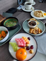 Indonesian Cuisine Nasi Goreng, Fried Chicken, Beef Rendang, Vegetable Soup, and Fresh Tropical Fruits Platter
