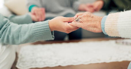 Woman, holding hands and support group for elderly care or trust for unity, community or social gathering at home. Closeup of women touching hand in teamwork activity, understanding or collaboration - Powered by Adobe