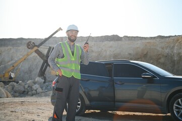 Worker and quarry in background