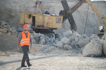 Worker and quarry in background