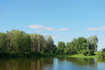 Landscape of a blue river with green forest.