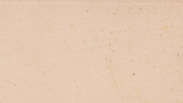 Vintage paper texture 4K stop motion video. Aged old page overlay effect background loop animation. Kraft paper texture with stains, grain, dust particles. Empty abstract animated backdrop