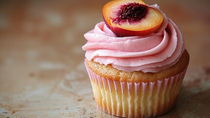   A pink-frosted cupcake topped with a fruit bite