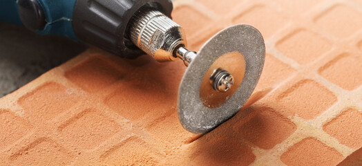 Diamond coated disc cutting brick or making grooves in concrete wall. Industry and construction.