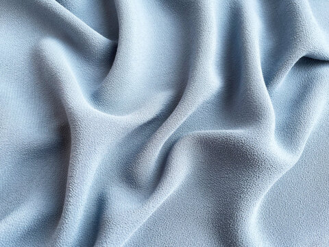folds of blue viscose fabric background