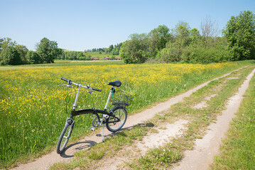 bike route around lake Seehamer See, buttercup meadow. folding bike on the way. landscape bavaria