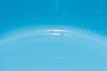 Blue water with ripples on the surface. Defocus blurred transparent blue colored clear calm water...