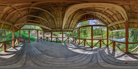 360 hdri panorama in equirectangular spherical projection in interior wooden gazebo near lake....