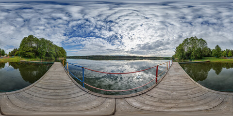 full seamless spherical hdri 360 panorama on wooden pier of lake or river in morning or sunset in...