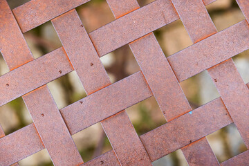 Abstract industrial photo. A grid of intertwined rusty metal strips