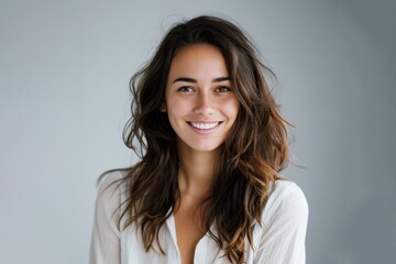 smiling happy attractive young woman posing in studio shot on grey background