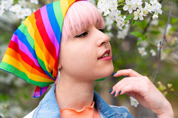 Portrait of LGBT young lesbian woman. A young woman with pink hair and a rainbow headband