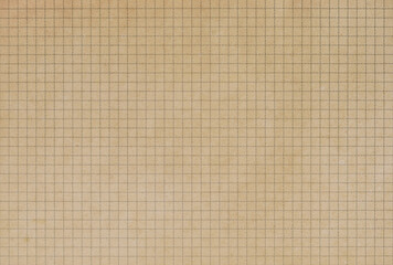 A sheet of old brown math grid paper, graph paper texture as background	