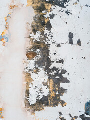 Fototapeta premium vertical surface wall is covered in cracks and has a rough texture