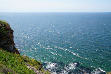view from the cliff to the sea horizon on a sunny day