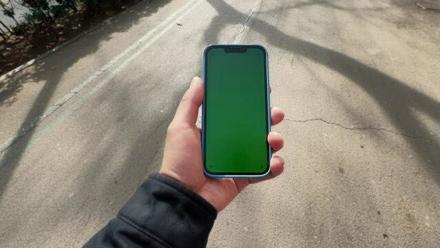 Man holding smart phone vertical or portrait orientation. Tourist walking at the city using maps app.