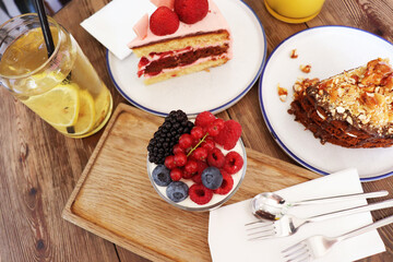 summer dessert with berries and cream and homemade lemonade on a wooden table