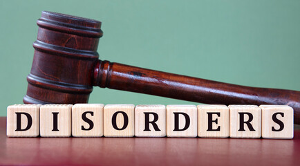 DISORDERS - word on wooden cubes on background of judge's gavel
